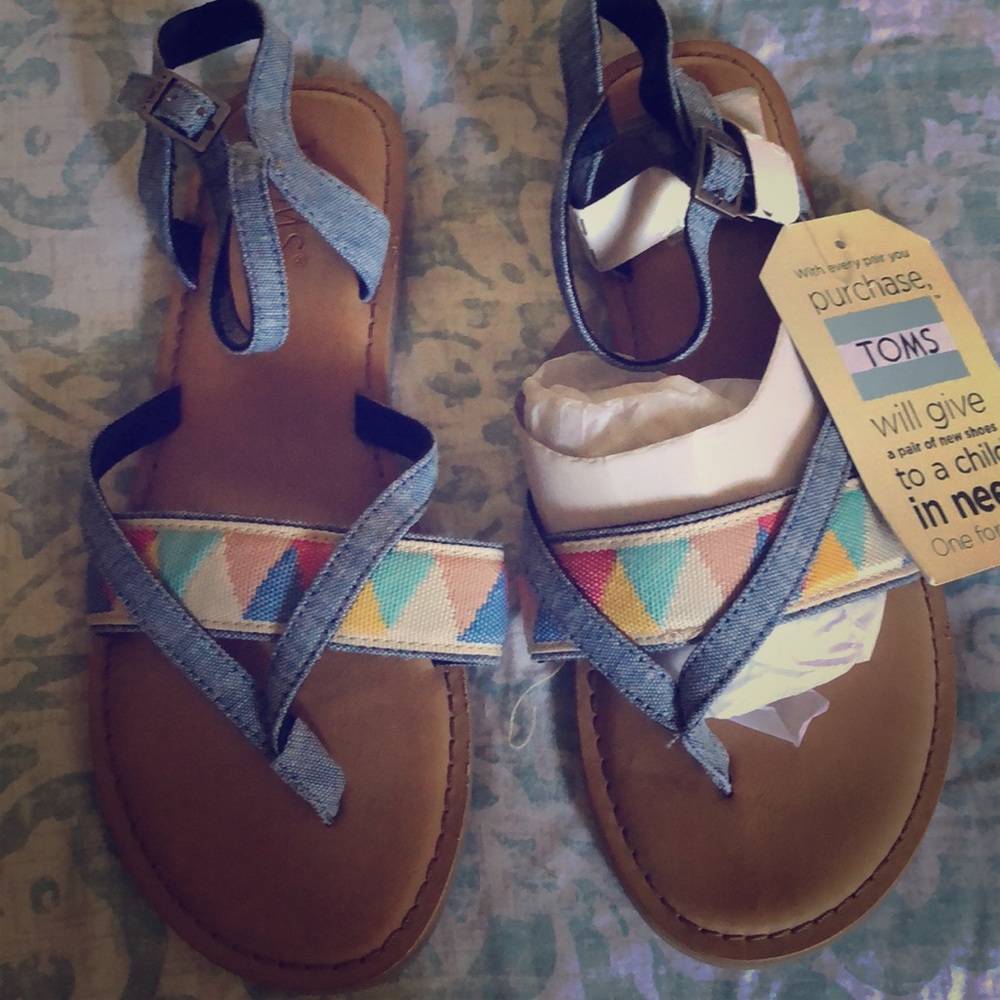 Brand new.  Never been worn Toms sandals